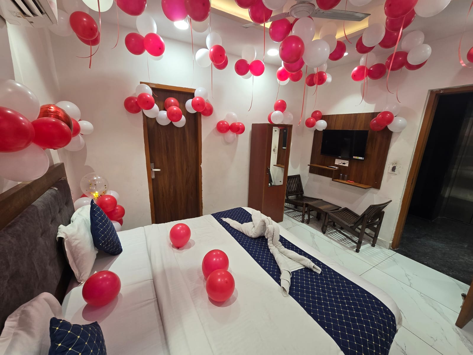 Decorated room with red and white balloons